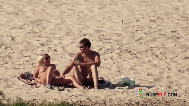Slim female with perky knockers naked at a naturist plage